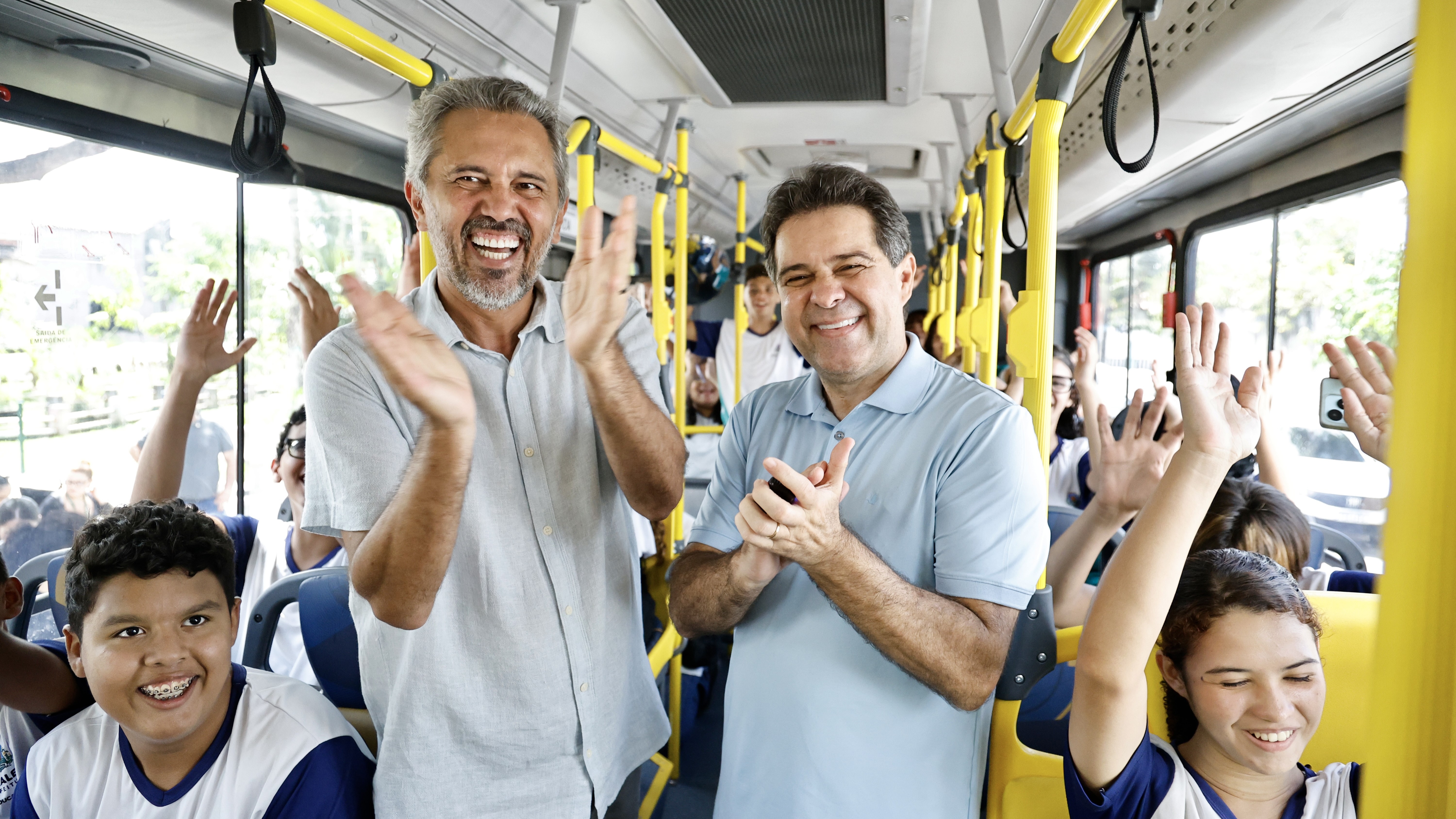 Governador Elmano e prefeito Evandro dentro de um ônibus com esttudantes